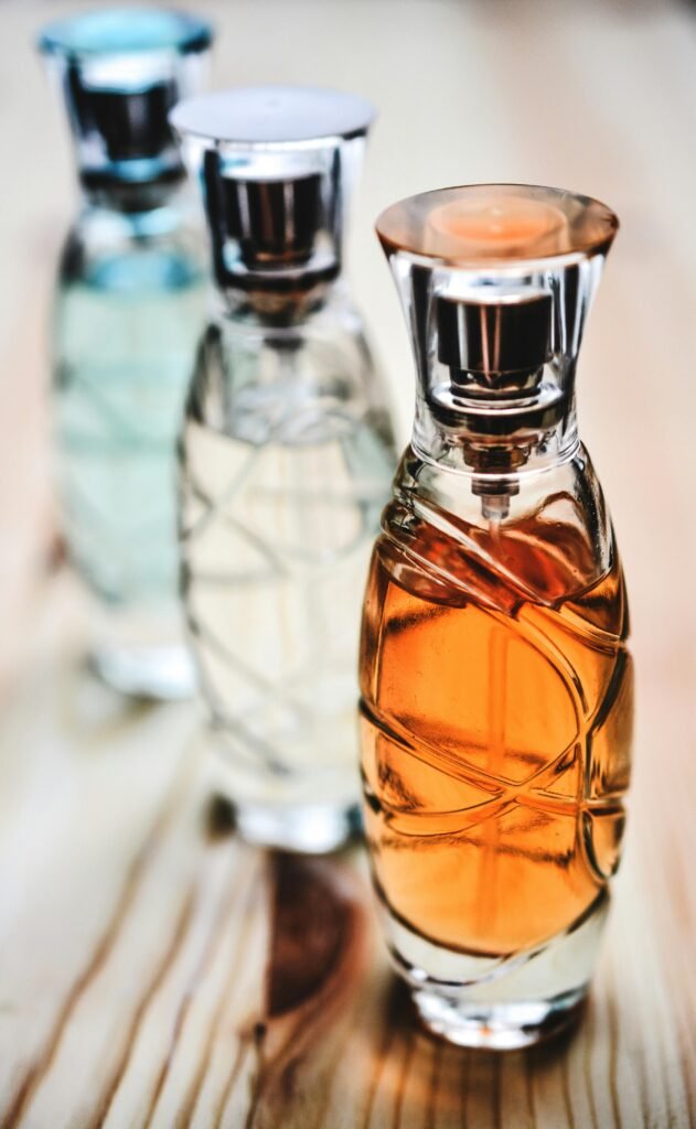 Beautiful collection of glass perfume bottles showcasing different fragrances on a wooden surface.